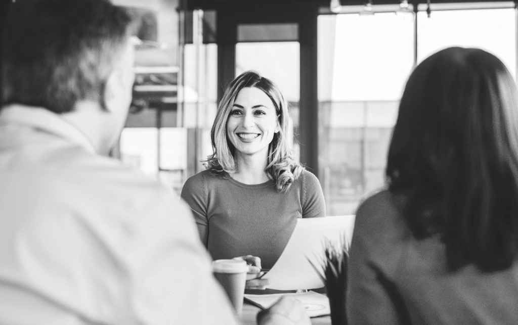 Financial advisor sitting with clients in their office.