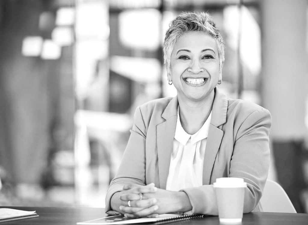 Portrait of a female financial advisor sitting behind her desk and smiling at the camera