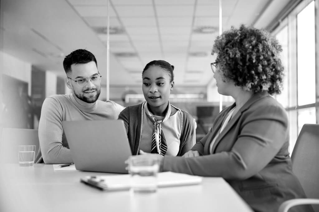 young-couple-and-their-financial-advisor-using-laptop-during-a-meeting-in-the-office