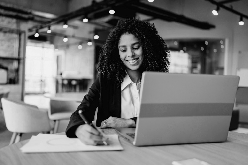 businesswoman-using-laptop-at-desk
