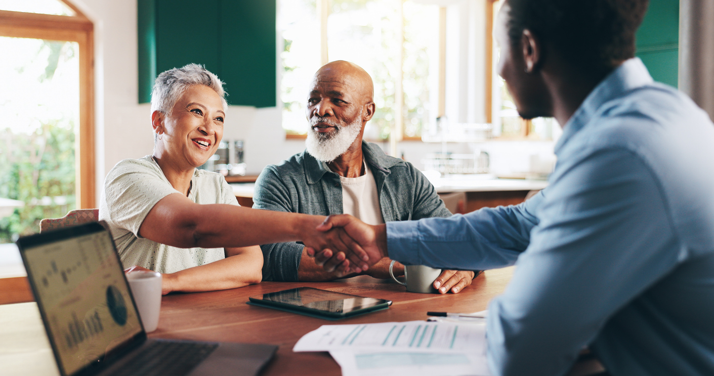 Older couple with financial advisor for retirement planning